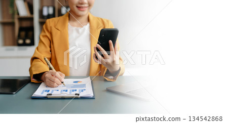 Businesswoman hand using laptop, tablet and smartphone in office. Digital marketing media mobile app and discussing plan new start up project. Businesswoman hand using laptop, tablet and smartphone in office. Digital marketing media mobile app and discussing plan new start up project. 134542868