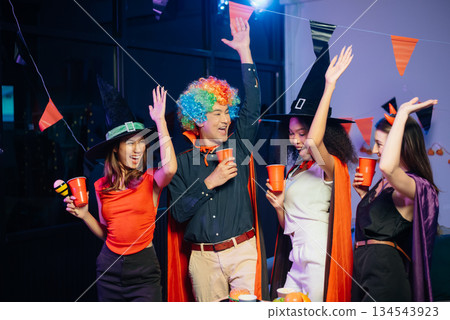 Celebration with friends enjoying food, drinks, and laughter at a lively house party. Perfect for themes of joy, togetherness, Celebration with friends enjoying food, drinks, and laughter at a lively house party. Perfect for themes of joy, togetherness, 134543923