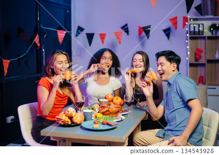 Celebration with friends enjoying food, drinks, and laughter at a lively house party. Perfect for themes of joy, togetherness, Celebration with friends enjoying food, drinks, and laughter at a lively house party. Perfect for themes of joy, togetherness, 134543928