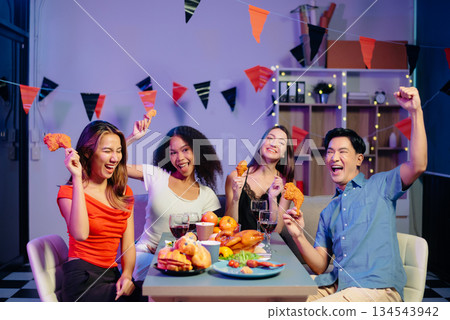 Celebration with friends enjoying food, drinks, and laughter at a lively house party. Perfect for themes of joy, togetherness, Celebration with friends enjoying food, drinks, and laughter at a lively house party. Perfect for themes of joy, togetherness, 134543942