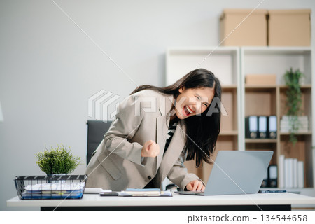 Beautiful Asian businesswoman typing laptop and tablet Placed at the table at the office 134544658