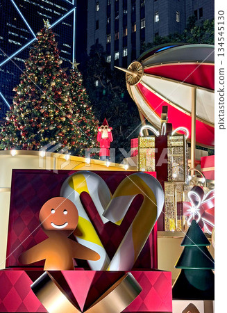 Festive Christmas decorations with gingerbread man, candy canes, and gifts at night Festive Christmas decorations with gingerbread man, candy canes, and gifts at night 134545130