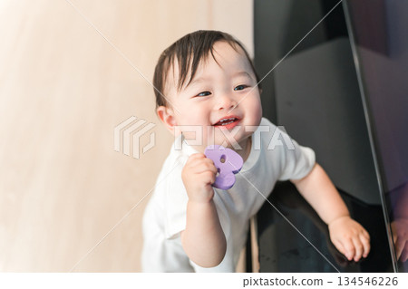 Baby standing up in the living room at home (walking, growth, development) Baby standing up in the living room at home (walking, growth, development) 134546226