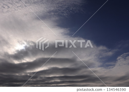 Nature Weather: Stratocumulus clouds, gray clouds beginning to spread across the blue sky. They are rapidly covering the sky. Nature Weather: Stratocumulus clouds, gray clouds beginning to spread across the blue sky. They are rapidly covering the sky. 134546390