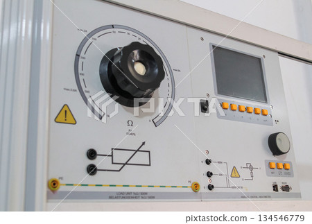 Interface panel of a precision electrical load unit featuring a large resistance selection knob, LCD display, input terminals, and hazard warning symbols. Interface panel of a precision electrical load unit featuring a large resistance selection knob, LCD display, input terminals, and hazard warning symbols. 134546779