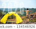 The start into the new year 2026. Young people tourist raise arm relax in tent after activity outdoor 134546926