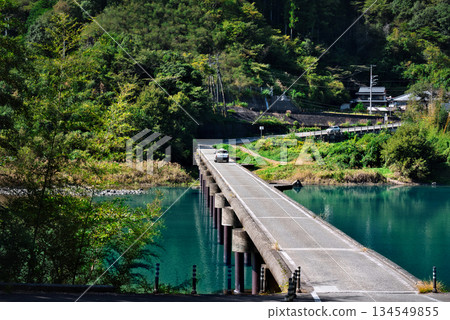 A taxi running over the Nagoeya Submerged Bridge A taxi running over the Nagoeya Submerged Bridge 134549855