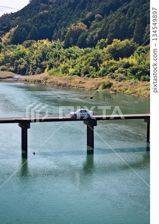 A taxi running over the Nagoeya Submerged Bridge A taxi running over the Nagoeya Submerged Bridge 134549897