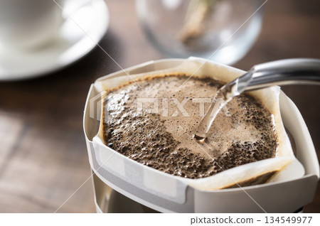 Brewing hot coffee with a drip bag for cups Brewing hot coffee with a drip bag for cups 134549977