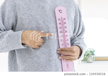 Man holding a large thermometer (Japanese, faceless, 30s) _ Winter Man holding a large thermometer (Japanese, faceless, 30s) _ Winter 134550516