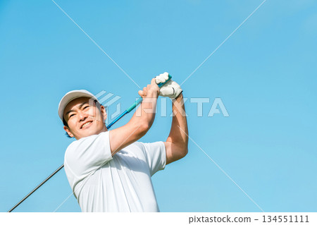 A golfer man playing golf at a golf course (smile, tee shot, golf competition) A golfer man playing golf at a golf course (smile, tee shot, golf competition) 134551111