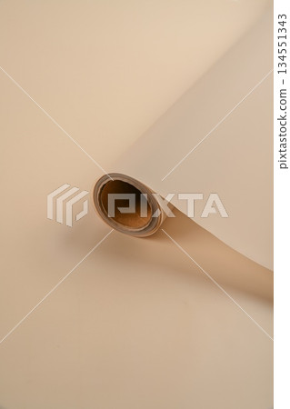 Rolled floral wrapping paper in soft neutral tones. Cream beige ivory and light sand color material for bouquets gift wrapping and flower shop design. 134551343