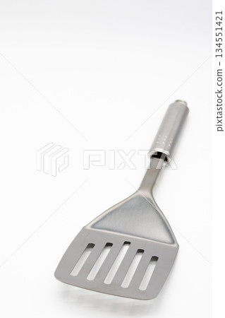 Stainless steel spatula placed on a white background Cookware/Kitchen image Stainless steel spatula placed on a white background Cookware/Kitchen image 134551421