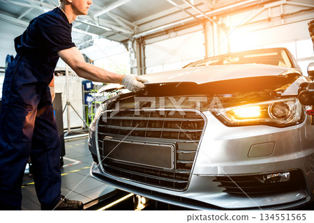 Car mechanic repair engine at service station. Car repair 134551565