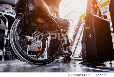 A man in a wheelchair inside of a specialized vehicle A man in a wheelchair inside of a specialized vehicle 134551699