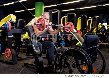 Disabled man training in the gym of rehabilitation center 134551730