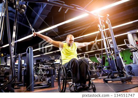 Disabled man training in the gym of rehabilitation center 134551747