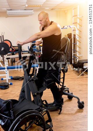 Disabled man training in the gym. Rehabilitation center Disabled man training in the gym. Rehabilitation center 134551751