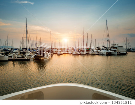 Beautiful view of marina and harbor with yachts and motorboats. Beautiful view of marina and harbor with yachts and motorboats. 134551811