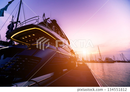Beautiful view of marina and harbor with yachts and motorboats.  134551812