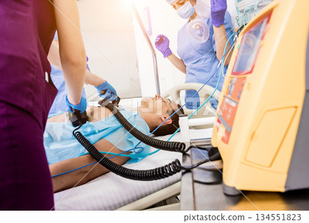 Doctors give resuscitation to a male patient in the emergency room. 134551823