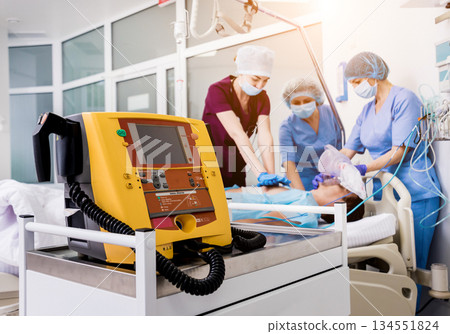 Doctors give resuscitation to a male patient in the emergency room. 134551824