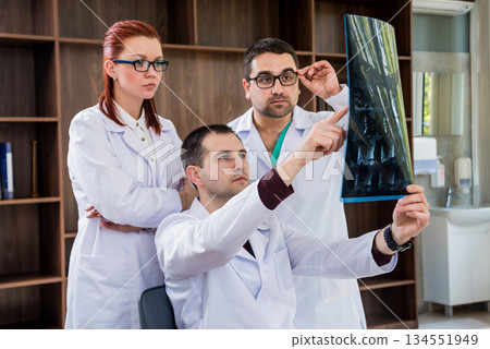 Doctors team having medical council in hospital. Discussing medical issues. Doctors team having medical council in hospital. Discussing medical issues. 134551949