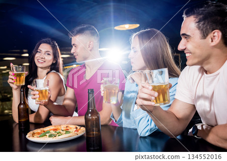 Cheerful friends in the pub. Drinking beer, wine and whisky Cheerful friends in the pub. Drinking beer, wine and whisky 134552016