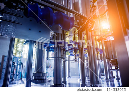 Bottling line of sunflower oil in bottles. Vegetable oil production plant. 134552055