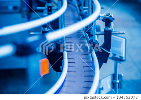 Bottling line of sunflower oil in bottles. Vegetable oil production plant. 134552078