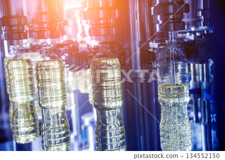 Bottling line of sunflower oil in bottles. Vegetable oil production plant 134552150