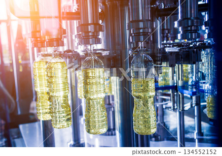 Bottling line of sunflower oil in bottles. Vegetable oil production plant 134552152