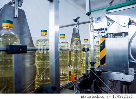 Bottling line of sunflower oil in bottles. Vegetable oil production plant 134552155