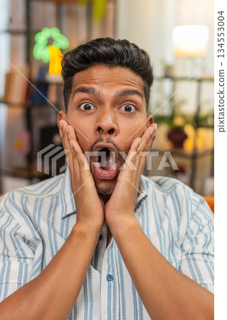 Indian man grabs cheeks and says wow after reading positive news shows big surprise joyful reaction Indian man grabs cheeks and says wow after reading positive news shows big surprise joyful reaction 134553004