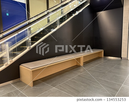 A rest area next to the escalator in a shopping center 134553253
