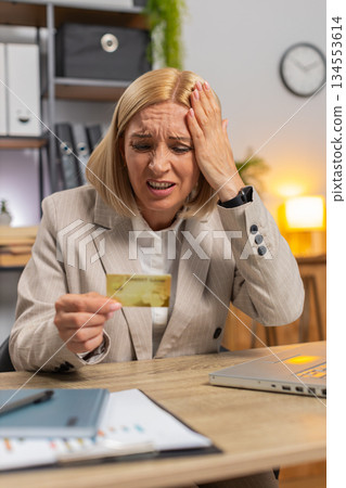 Angry mad stressed businesswoman trying to pay online shopping with blocked credit card smartphone 134553614