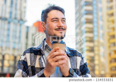 Happy Caucasian middle-aged man tourist enjoying morning coffee hot drink on city downtown street Happy Caucasian middle-aged man tourist enjoying morning coffee hot drink on city downtown street 134553831