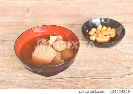 boiled hot tofu pudding in ginger syrup on bowl with crispy deep-fried dough stick 134554259