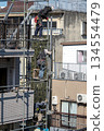 Workers at an apartment building demolition site 134554479