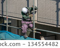 Workers at an apartment building demolition site 134554482