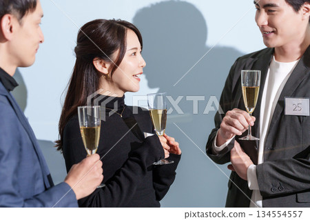 Men and women in their 30s talking at a matchmaking party Men and women in their 30s talking at a matchmaking party 134554557
