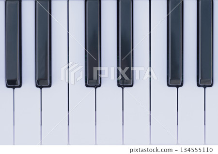 Black and white keys of a keyboard, providing a geometric pattern and musical composition 134555110