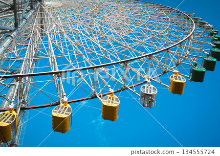 Ferris wheel against the blue sky 134555724