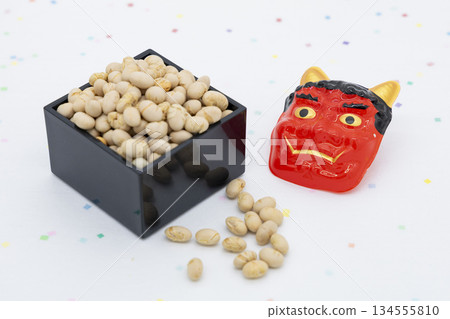 Lucky beans in a wooden box and a red demon arranged on a white background 134555810