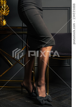 Female legs in black tights and pencil skirt Female legs in black tights and pencil skirt 134555888