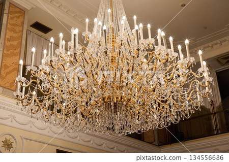 Intricate Gold Chandelier Closeup Highlighting Artistic Craftsmanship And Classic Design Features Intricate Gold Chandelier Closeup Highlighting Artistic Craftsmanship And Classic Design Features 134556686