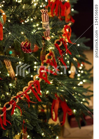 Festive Holiday Decor, Elegant Tree With Festive Touches, Warm Lit Display With Luxurious Seasonal Details 134556689