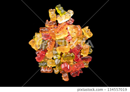 Macro shot assorted colorful gummy candies isolated on black background. Top view candy pattern. Jelly bears background texture. Macro shot assorted colorful gummy candies isolated on black background. Top view candy pattern. Jelly bears background texture. 134557019
