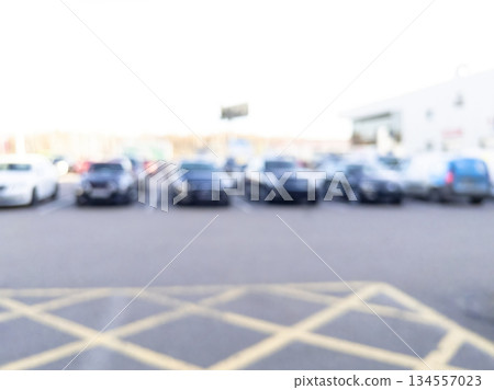 Blurred background with cars on the street. Bokeh lights background. Abstract blur car parking lot for background. Blurred cars parking. Bokeh light Blurred background with cars on the street. Bokeh lights background. Abstract blur car parking lot for background. Blurred cars parking. Bokeh light 134557023