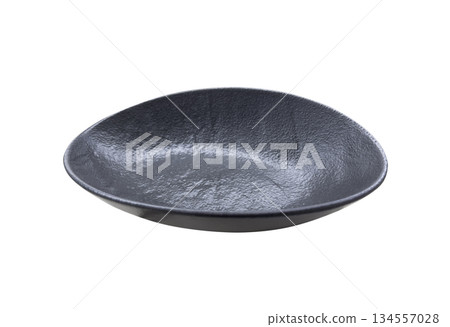 Empty black ceramic plate isolated on a white background.Black dish isolated. Empty black ceramic plate isolated on a white background.Black dish isolated. 134557028